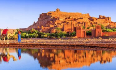 Tourists walking through Ait Ben Haddou during a day trip to Ouarzazate from Marrakech